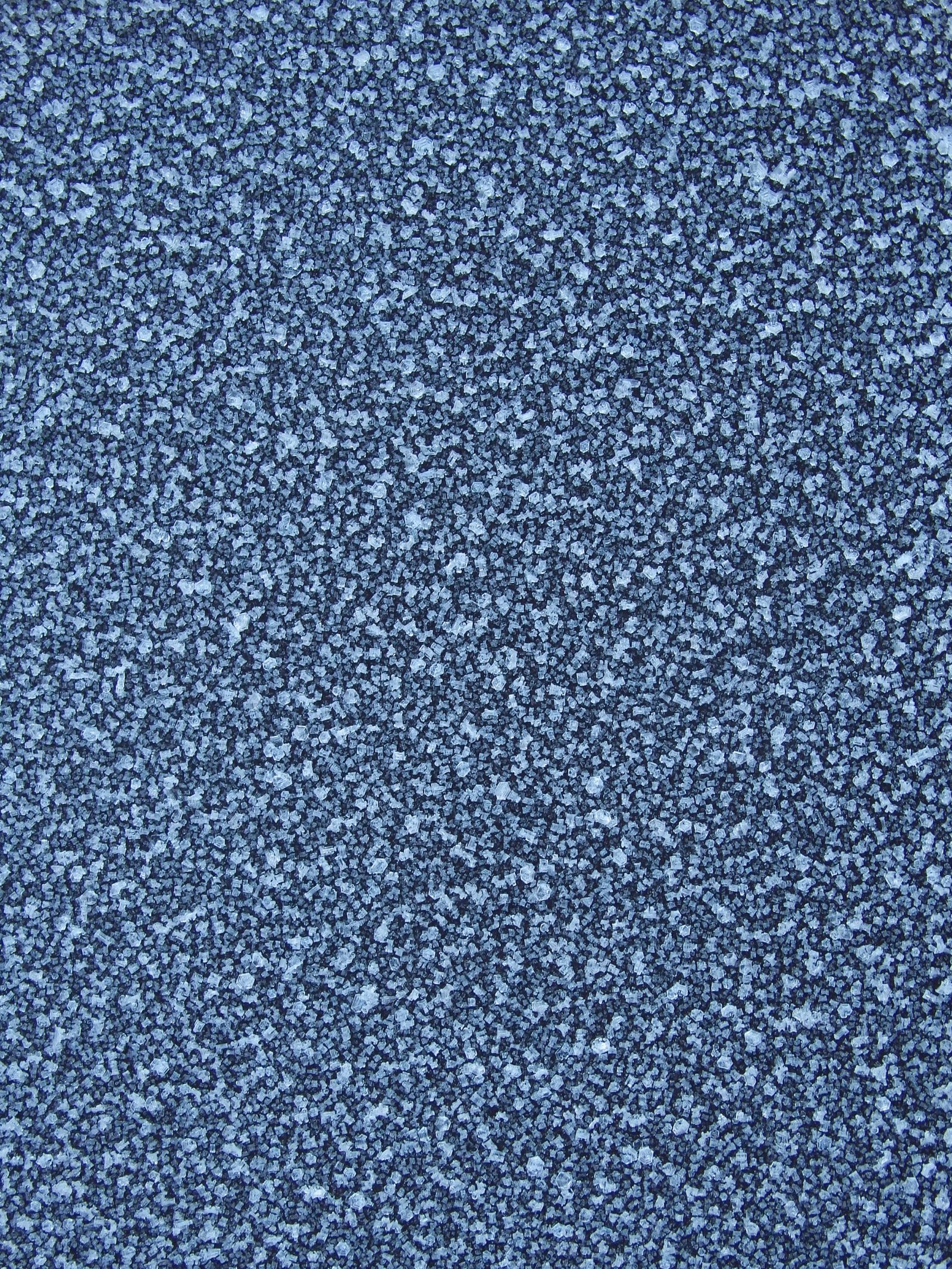 Blue frost texture on the surface. Winter background. Ice texture background. Frost, ice surface. Close up of decorative winter frozen pattern.